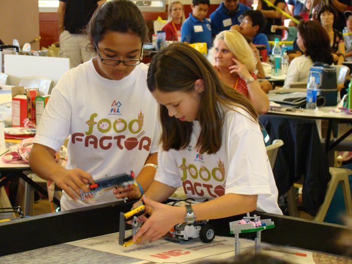 (Photo courtesy of Junior Casey Correa) Young students maneuver their Lego robots through various food-related missions in the latter part of the FIRST Lego League District Tournament. 