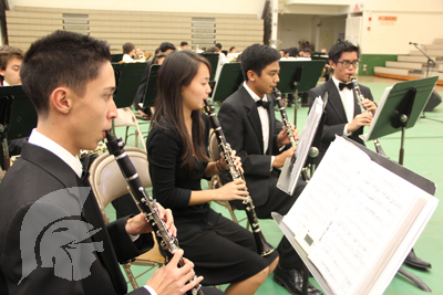 (Photo courtesy of Junior Rachel Yonamine) (L-R): Seniors J. Burchette and H. Hayashi, Junior S. Kaya and Senior K. Robles, warm-up on their clarinets before the concert.