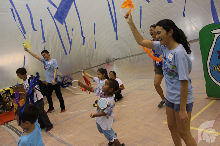 (Photo courtesy of assistant student activities coordinator Danielle Castro) As one of the playday activities, Senior Laura Ambrosecchio (right) and Junior Austin Ajimura, led
singing, dancing and games within a plastic bubble that students and preschoolers could stand inside.
