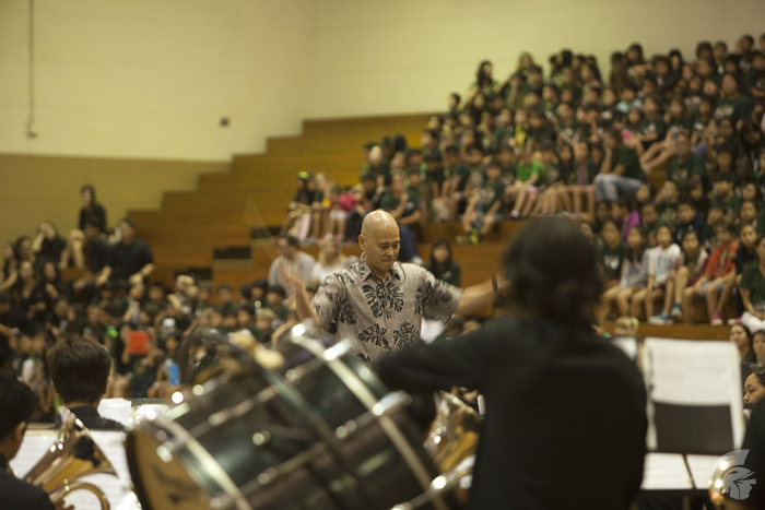 (Paul Park | Trojan Times) Band Director Curtis Hiyane conducts the MHS band students in order to help them keep pace with the song as the elementary students watch.