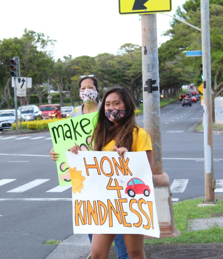 ASMHS students volunteer on kindness day, holding signs to spread cheer to all passing by.
(Photo Courtesy: ASMHS)