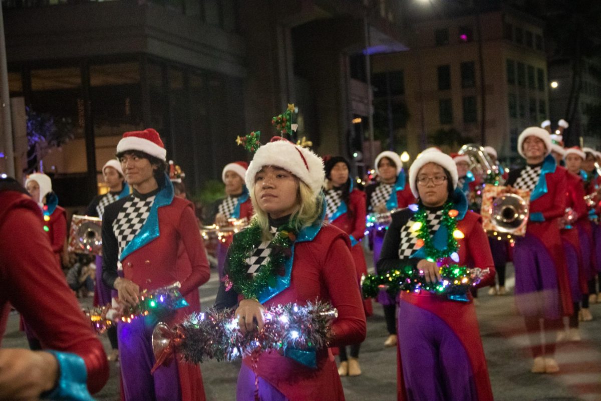 Left to right: Trumpets Rylan Akau-Morgan, Peyton Kahiapo and Skylar Hamasu stand in first position during the City of Lights Parade on Dec. 2.