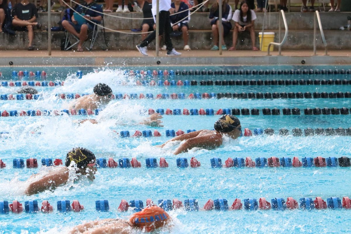 During the Oahu Interscholastic Association (OIA) Championship finals of the women’s 100 yard butterfly, Belise Swartwood takes home first place with a time of 56.56 seconds. This was one of four first place titles that Swartwood earned during the championship.